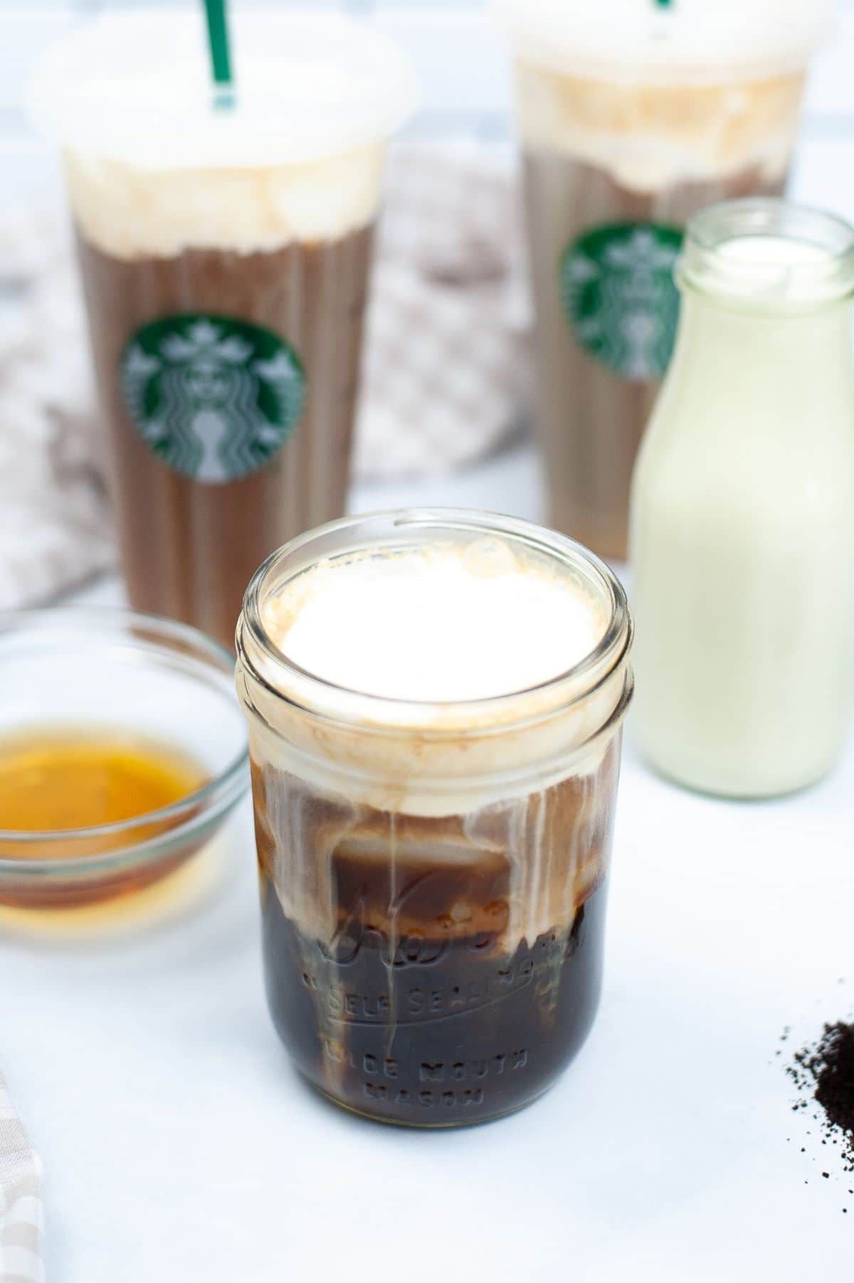 Starbucks Copycat Vanilla Sweet Cream mixed into a glass of cold coffee.