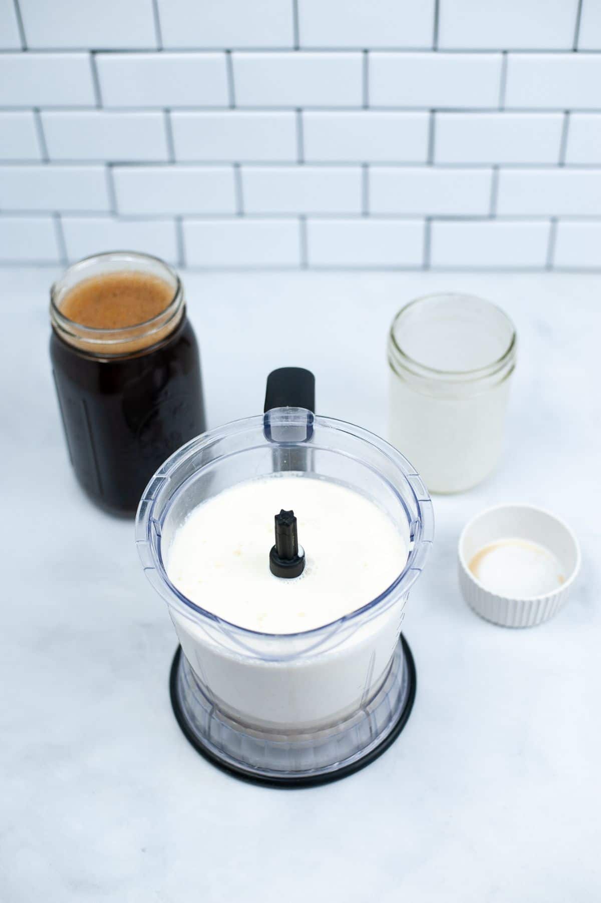 Condensed milk, cream, and vanilla in a blender to form sweet cream.