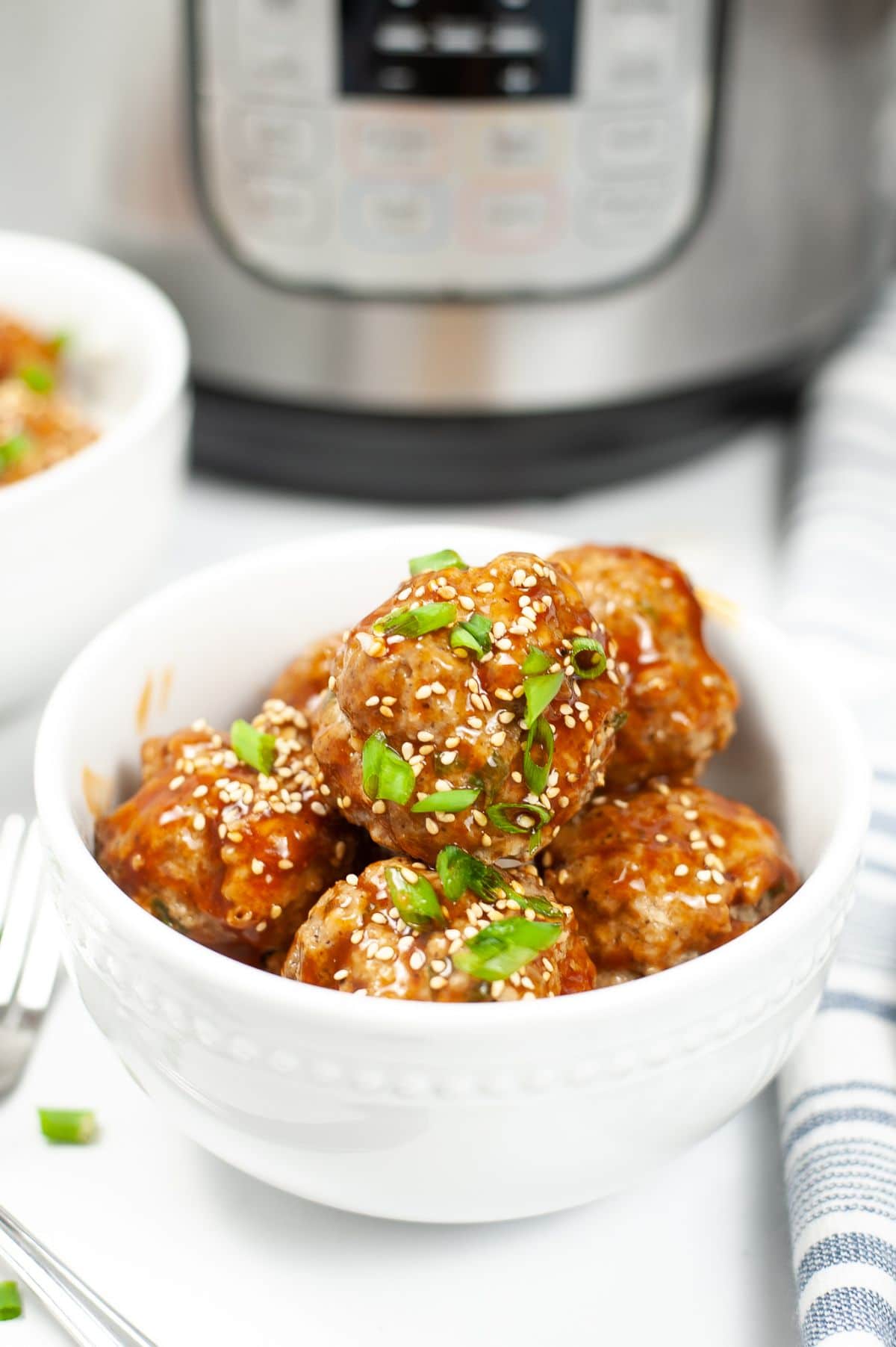 Instant Pot Asian Meatballs in a white serving bowl.