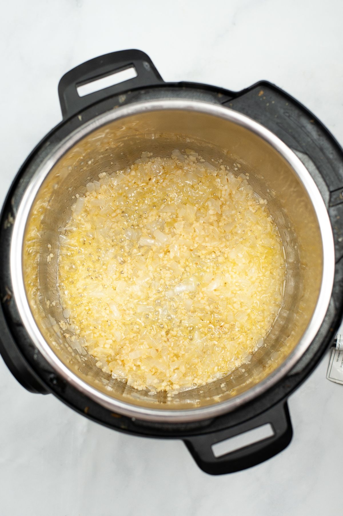 Onion and garlic sauted in an Instant Pot.