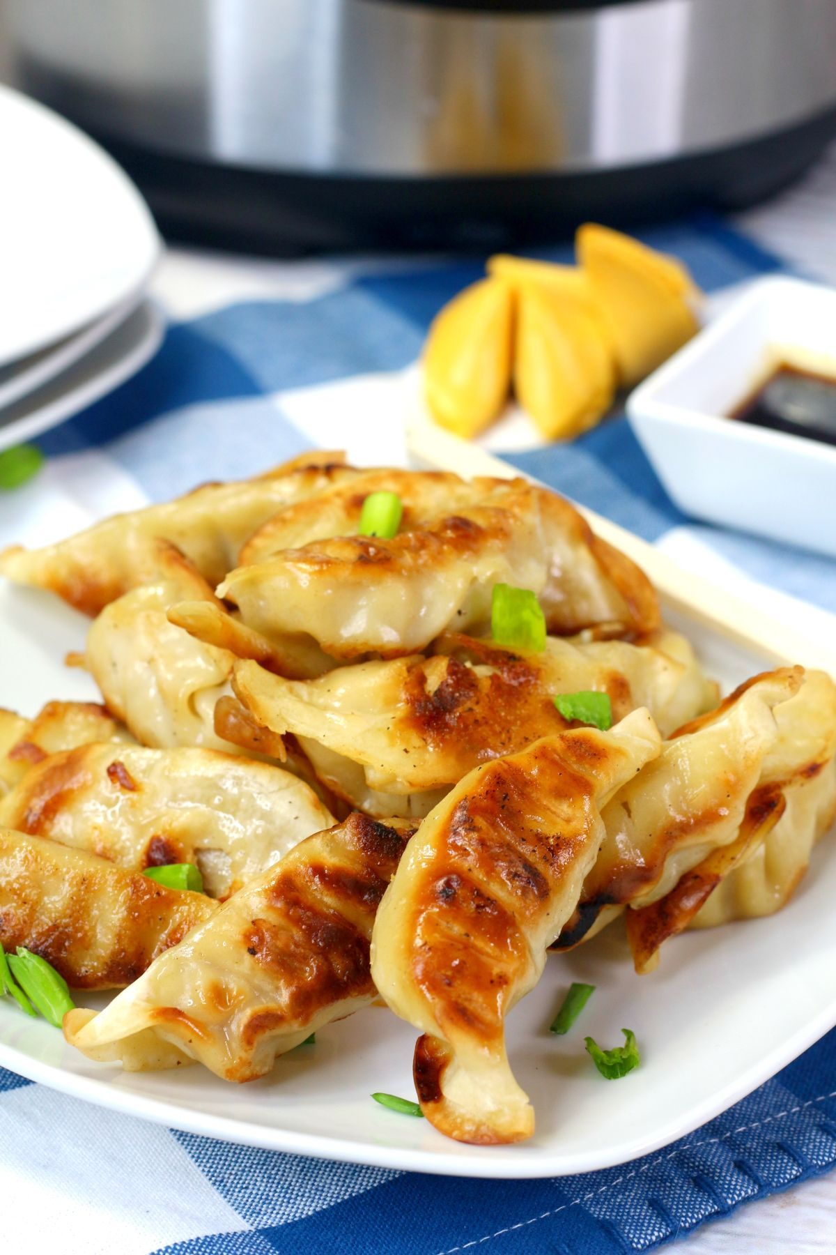 close up of Instant Pot Potstickers on a white serving plate.