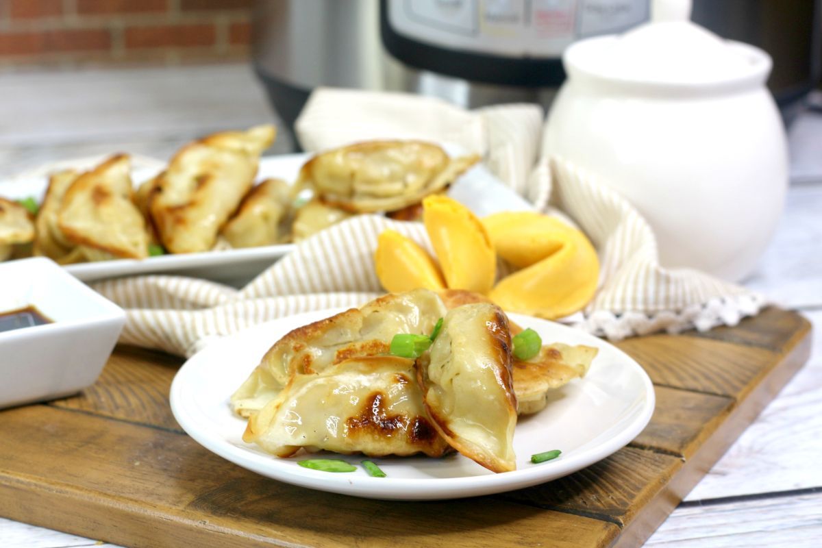 Horizontal image of Instant Pot Potstickers on a white serving plate.
