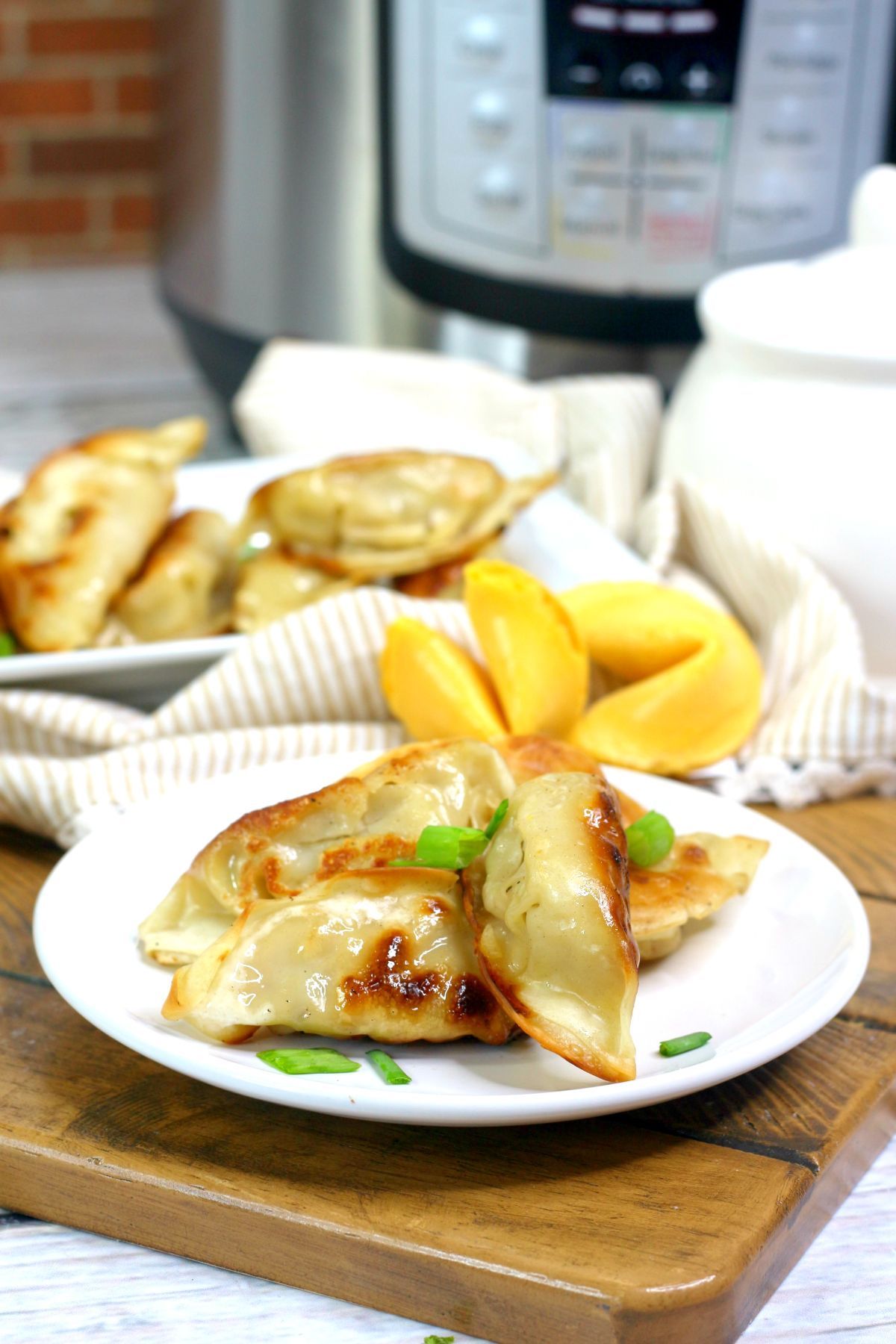 Instant Pot Potstickers on a white serving plate.
