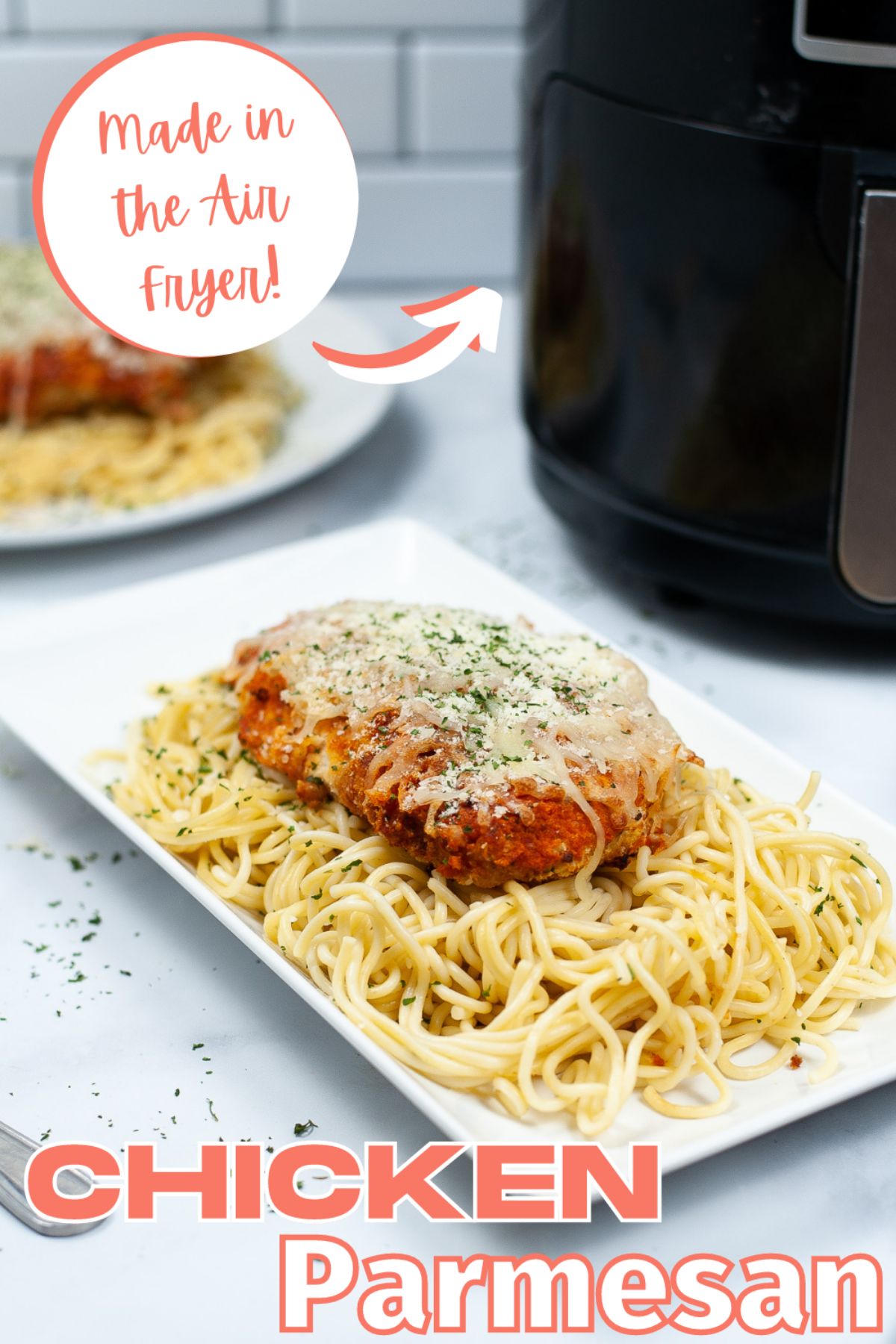 Air Fryer Chicken Parmesan on top of pasta on a white platter with a text bubble above it saying "Made in the Air Fryer" and a printed text below it saying "Chicken Parmesan"