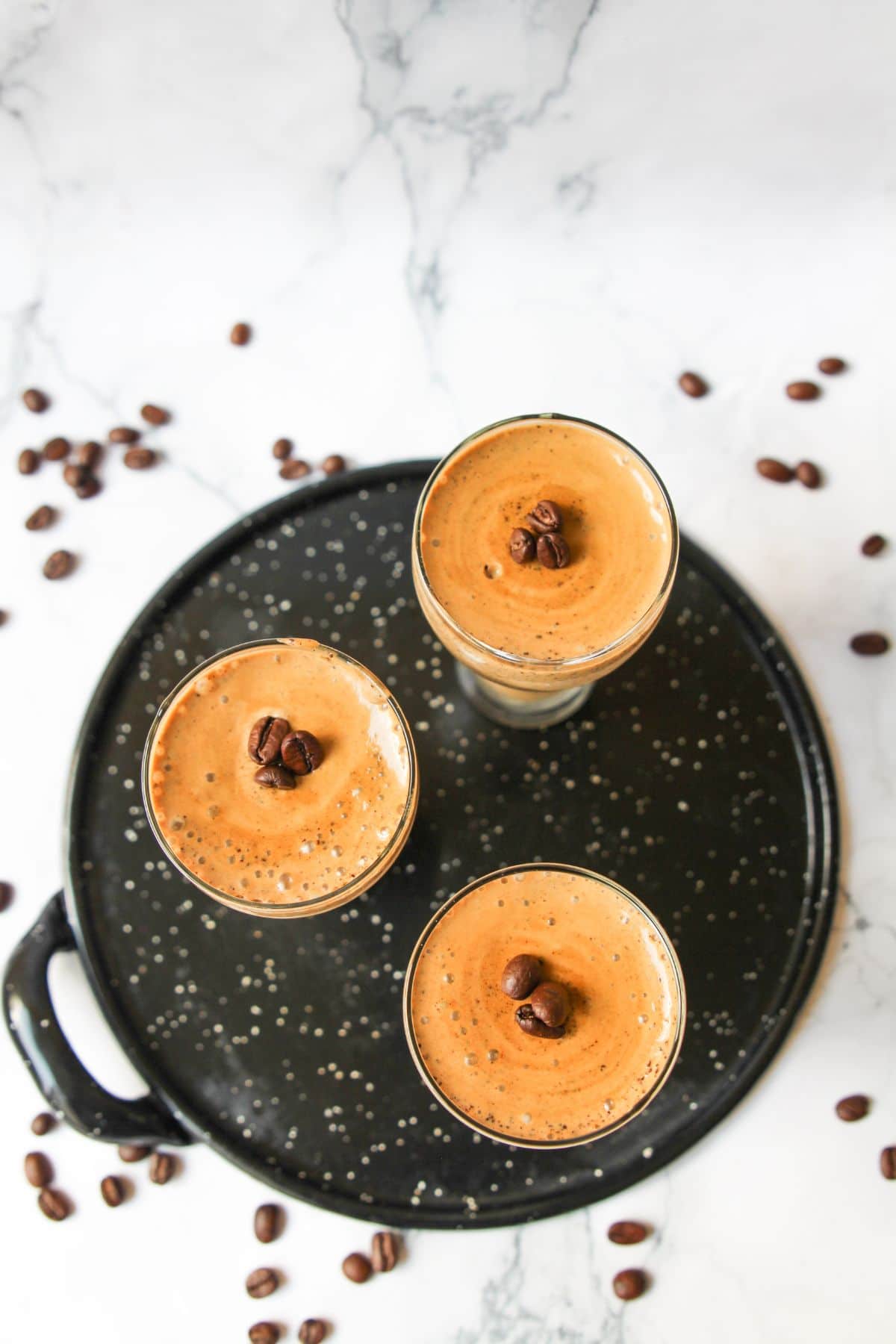 Overhead vertical shot of three tall glasses filled with Coffee Mousse topped with chocolate chips.