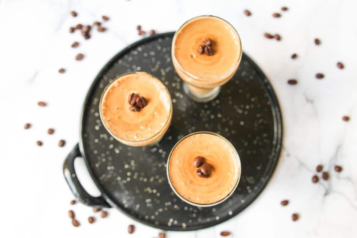Overhead horizontal shot of three tall glasses filled with Coffee Mousse topped with chocolate chips.