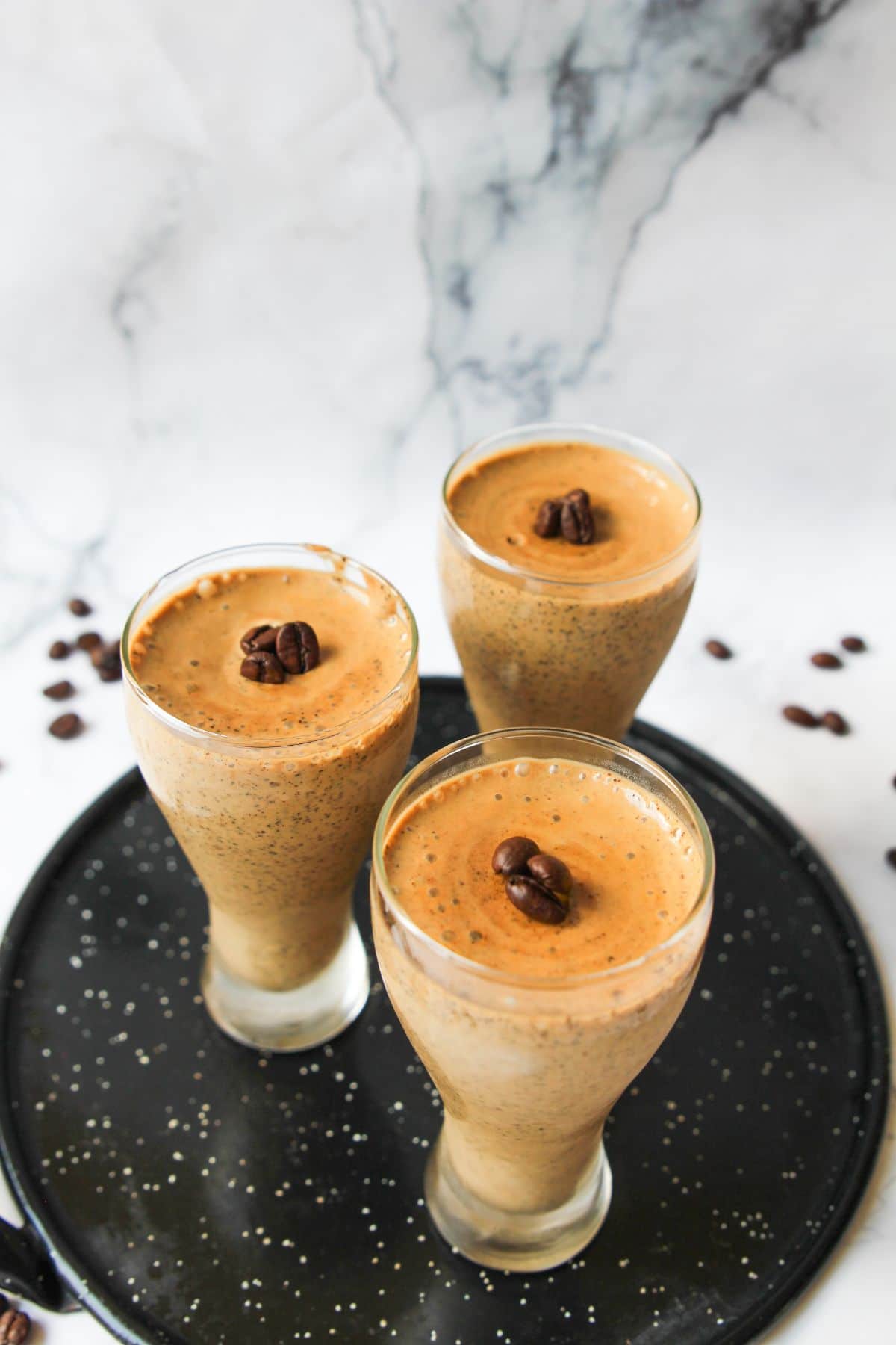 Three tall glasses filled with Coffee Mousse topped with chocolate chips.