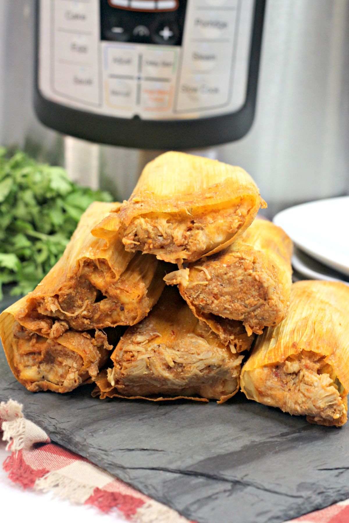 6 Instant Pot Chicken Tamales stacked like a pyramid.