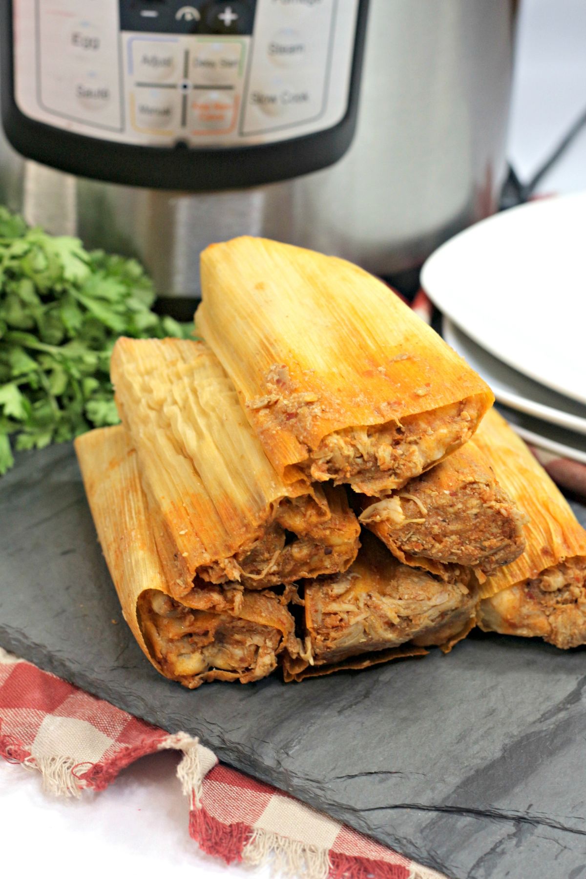 6 Instant Pot Tamales stacked like a pyramid.