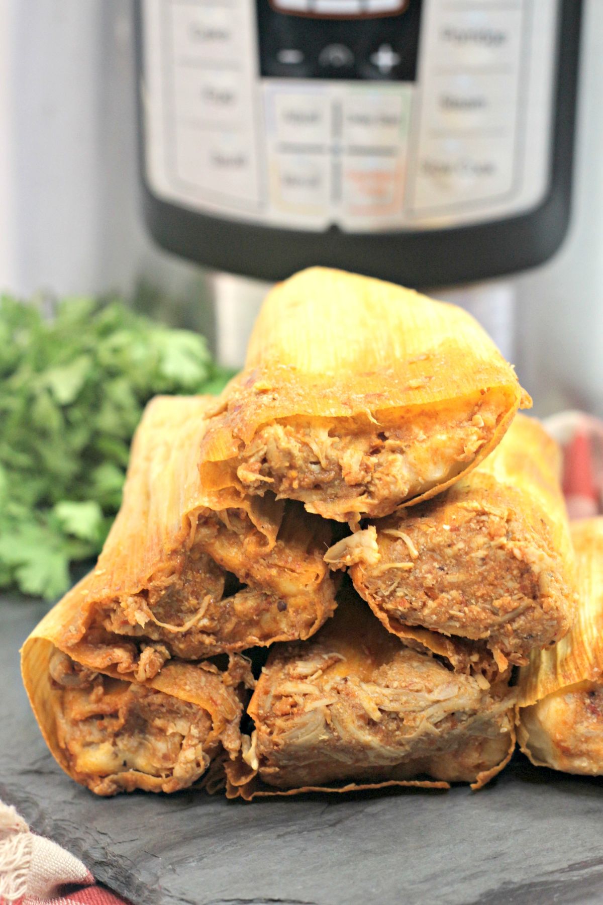 Close up shot of 6 Instant Pot Chicken Tamales stacked like a pyramid.
