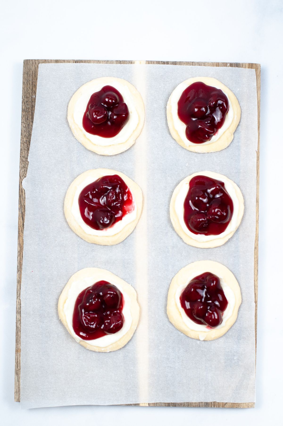 6 pcs Danish dough flattened in 2-3" circle size topped with cream cheese mixture and cherries.