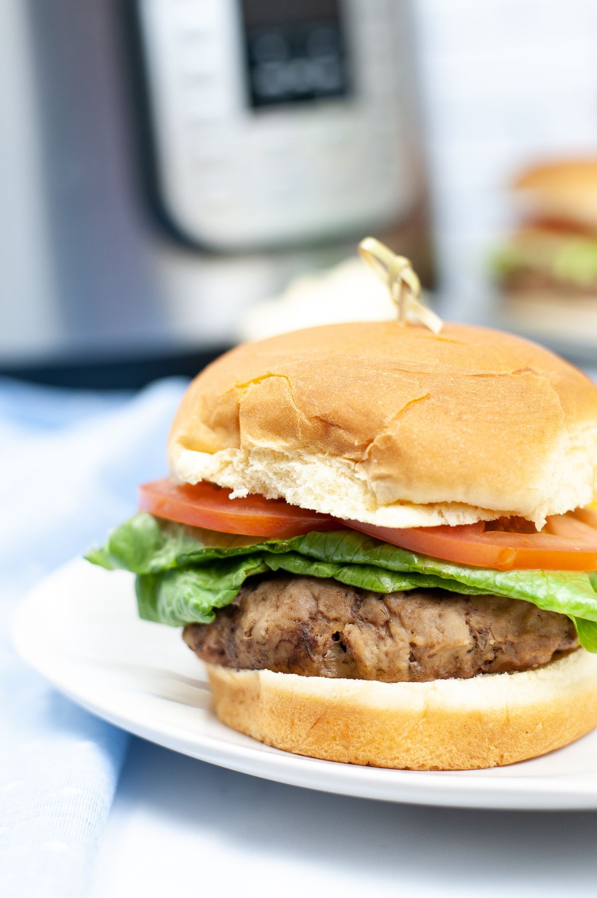 closeup of an Instant Pot Turkey Burger on a white square plate
