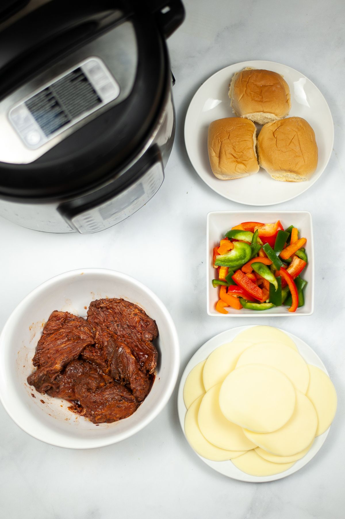 Instant Pot Philly Cheesesteak Sliders ingredients and an instant pot