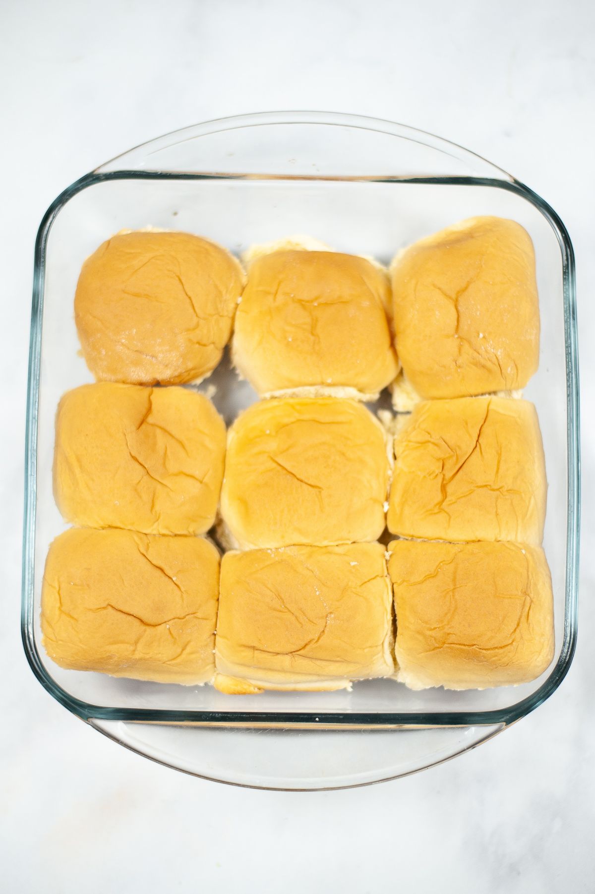 9 pcs dinner rolls in a square glass dish