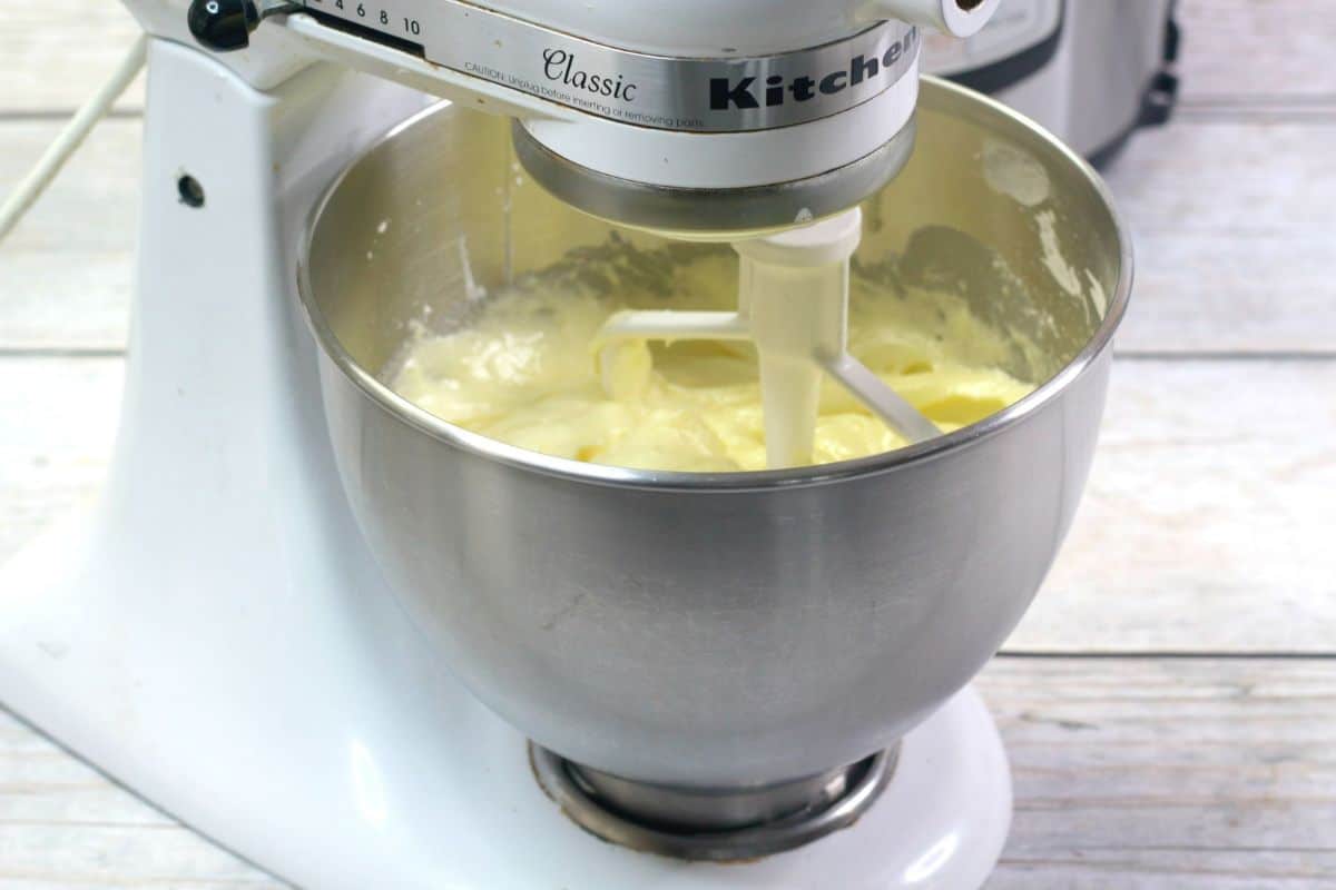 butter, sugar vanilla, lemon juice and cream blended together in a mixing bowl