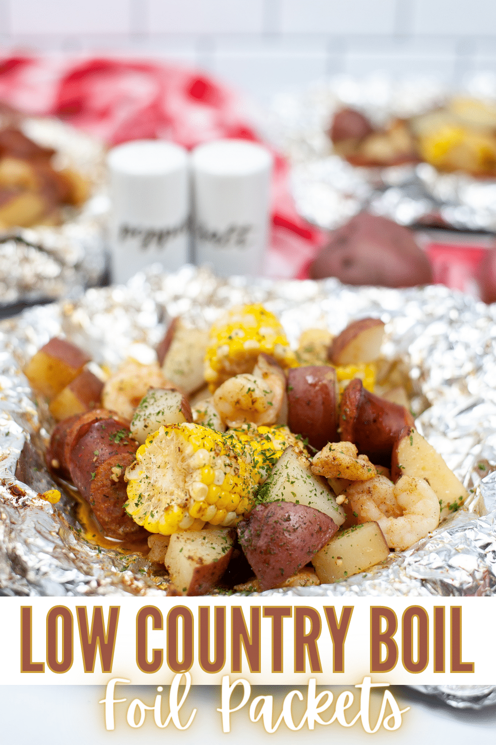 Low Country Boil Foil Packet with salt and pepper shakers blurred in the background with title text reading Low Country Boil Foil Packets