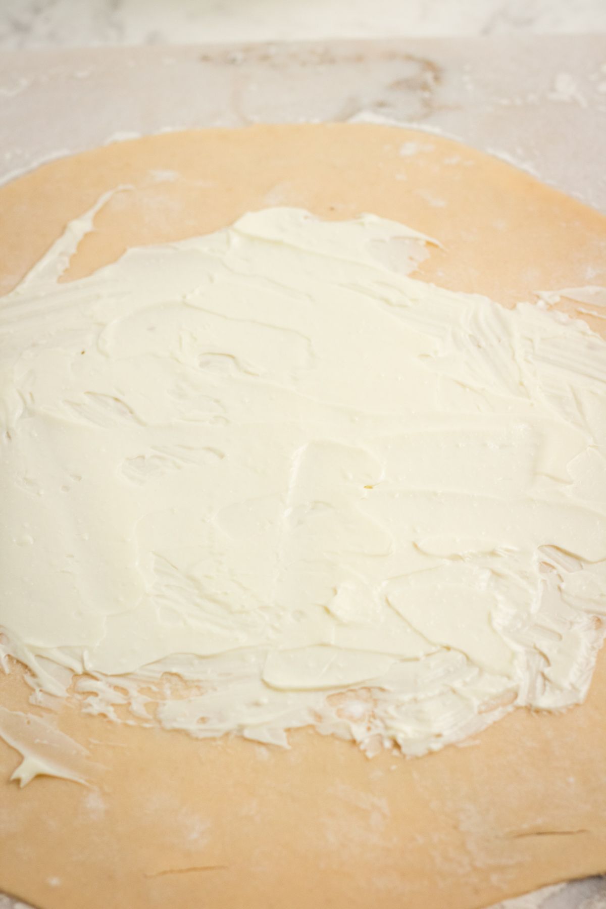 pie dough spread with cream cheese.