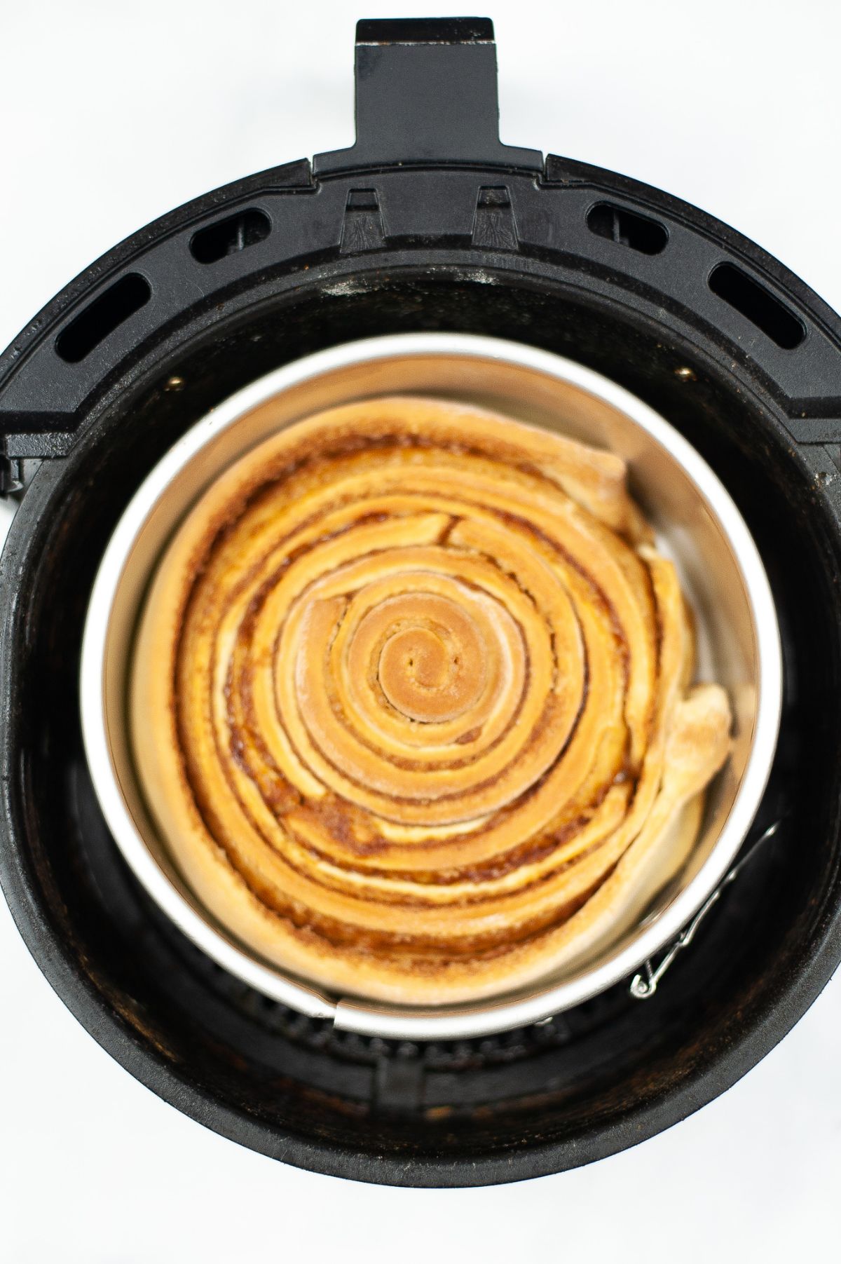 Air Fryer Copycat Cinnabon Cinnamon Rolls in a springform pan in an air fryer