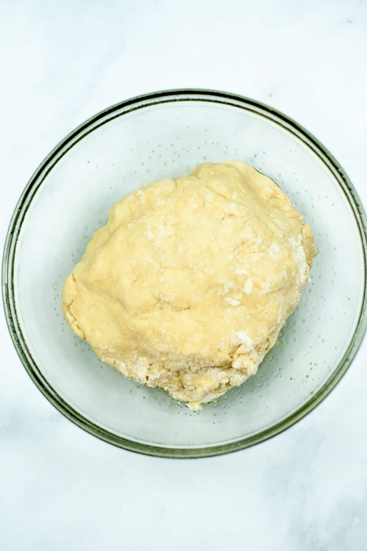 cinnamon roll dough in a clear bowl