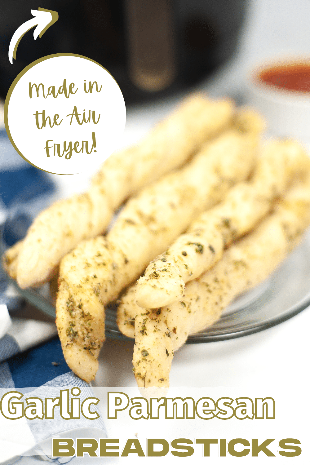Air Fryer Breadsticks on a glass plate with title text reading Garlic Parmesan Breadsticks Made in the Air Fryer