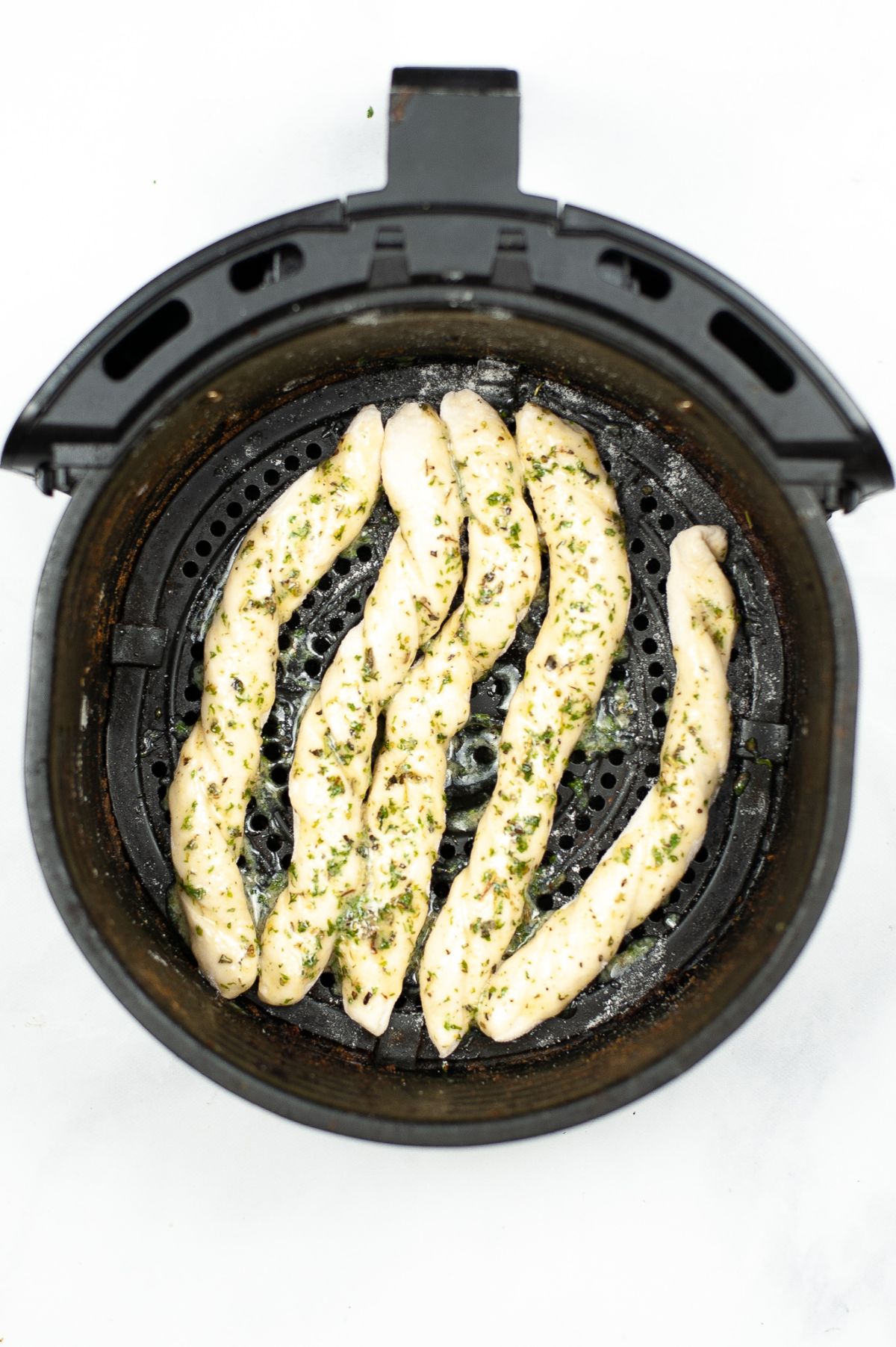 Breadsticks inside the air fryer before being cooked