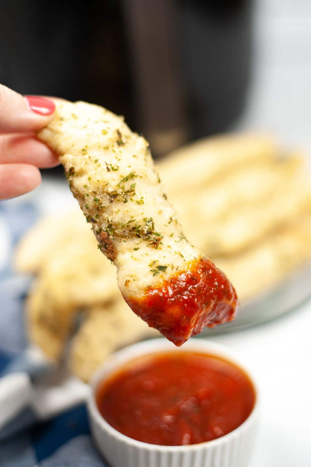 Air Fryer Garlic Parmesan Breadstick being dipped in a dipping sauce
