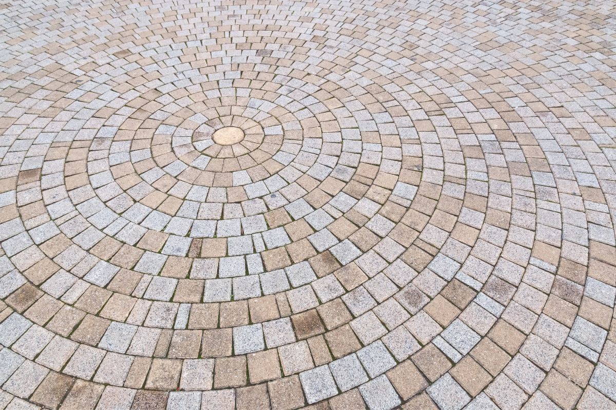 decorative brick patio with bricks arranged in circular pattern
