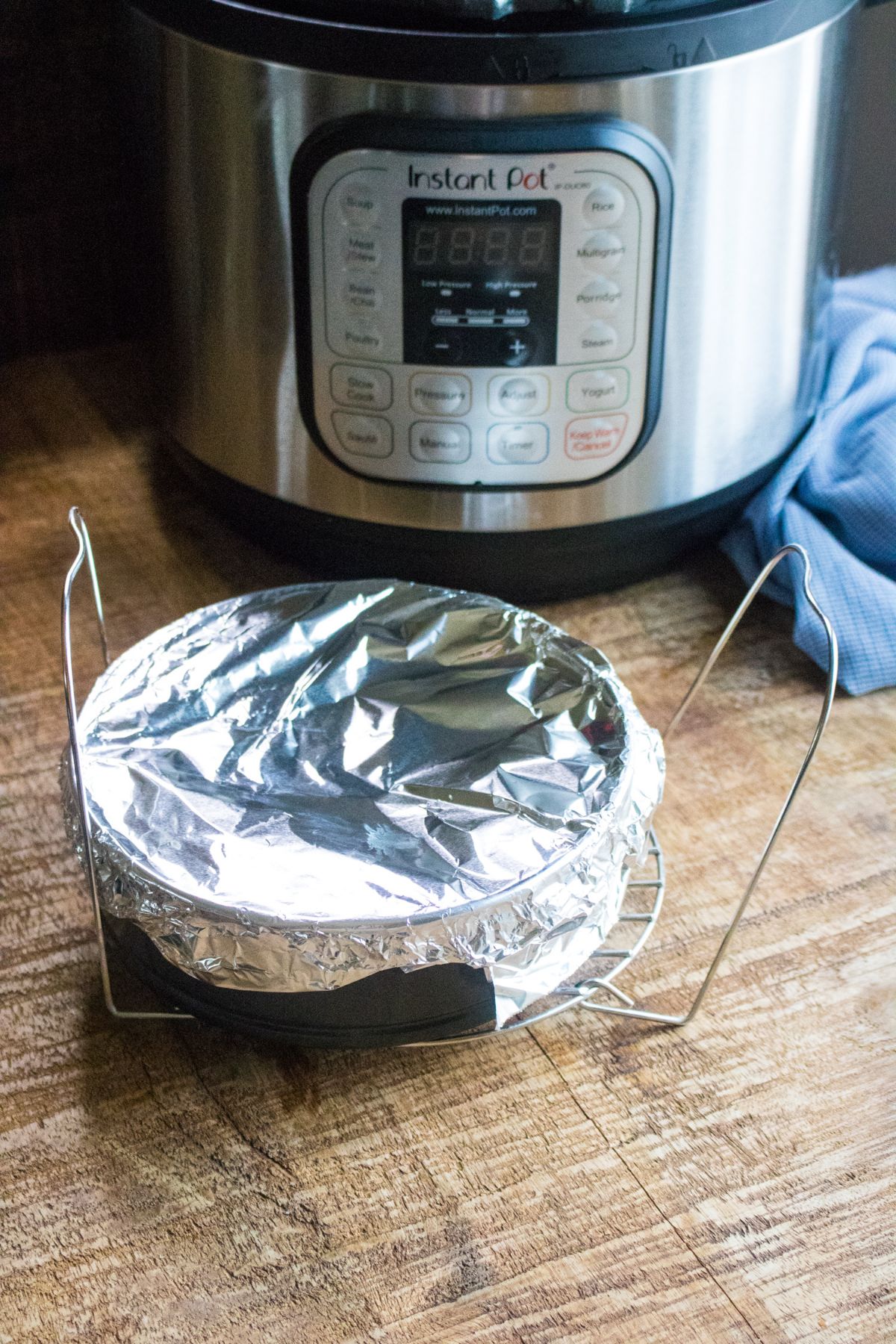 pan covered in foil next to an instant pot and blue cloth