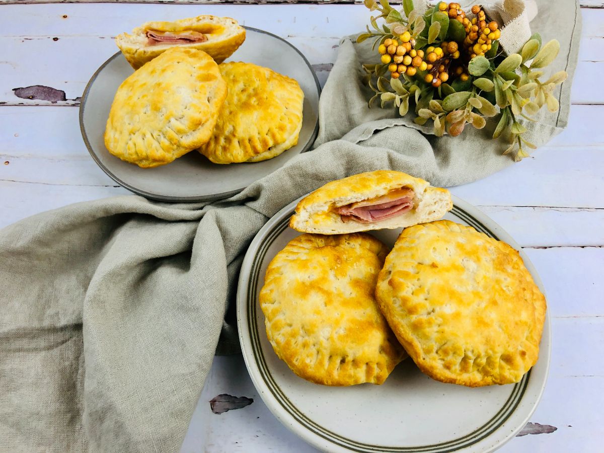 Air Fryer Hot Pockets on two different plates next to a green cloth with a plant on it
