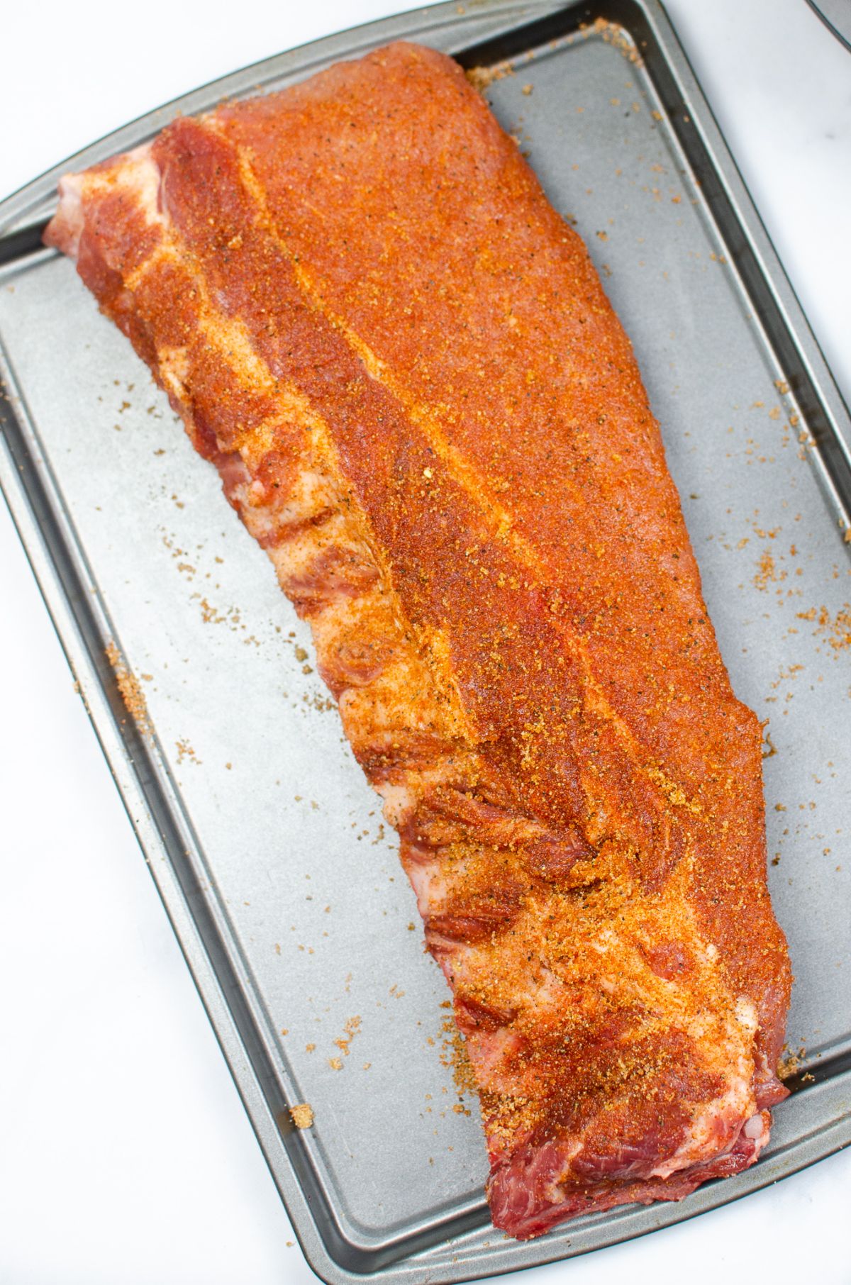 uncooked ribs rubbed with seasoning