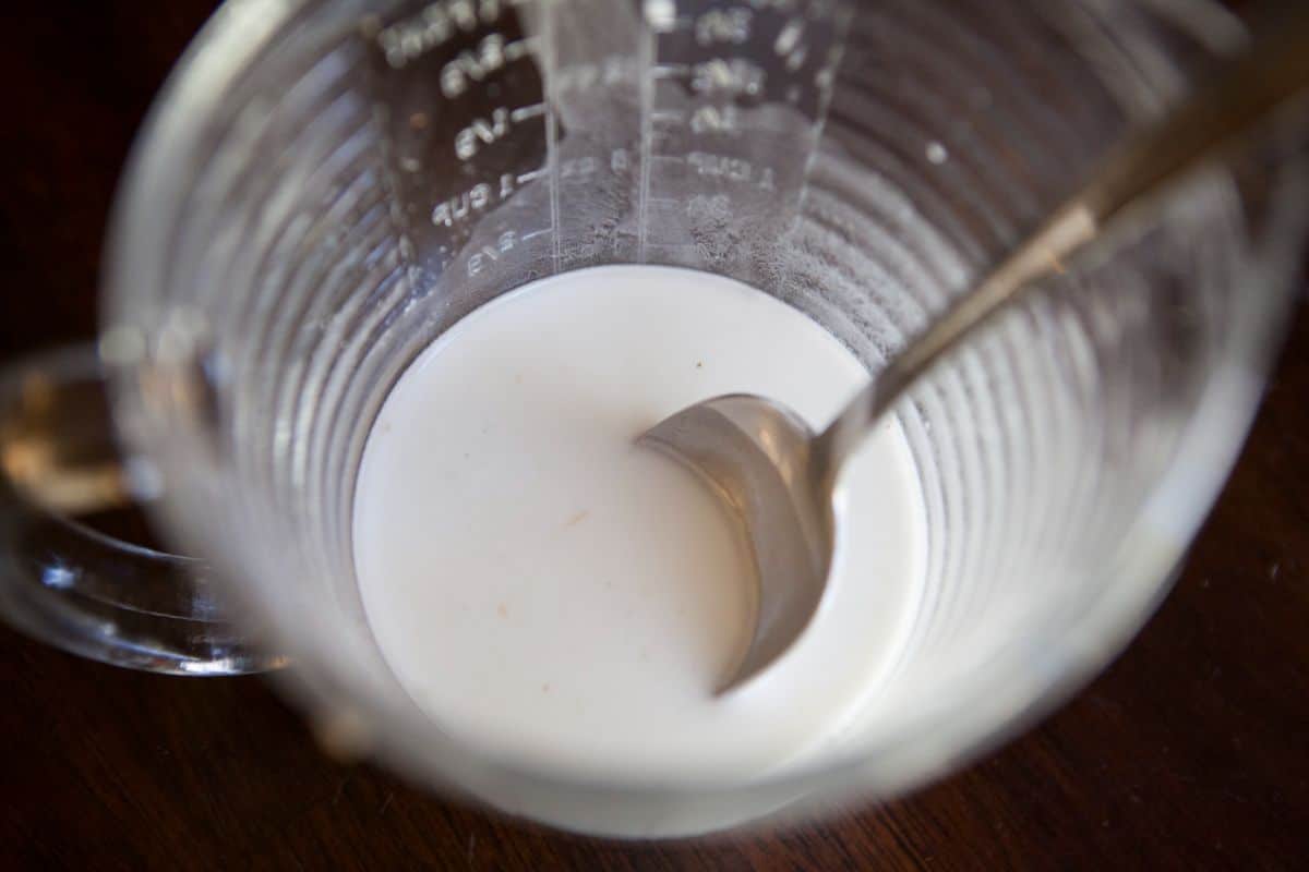 cornstarch mixture and a spoon in a glass measuring cup