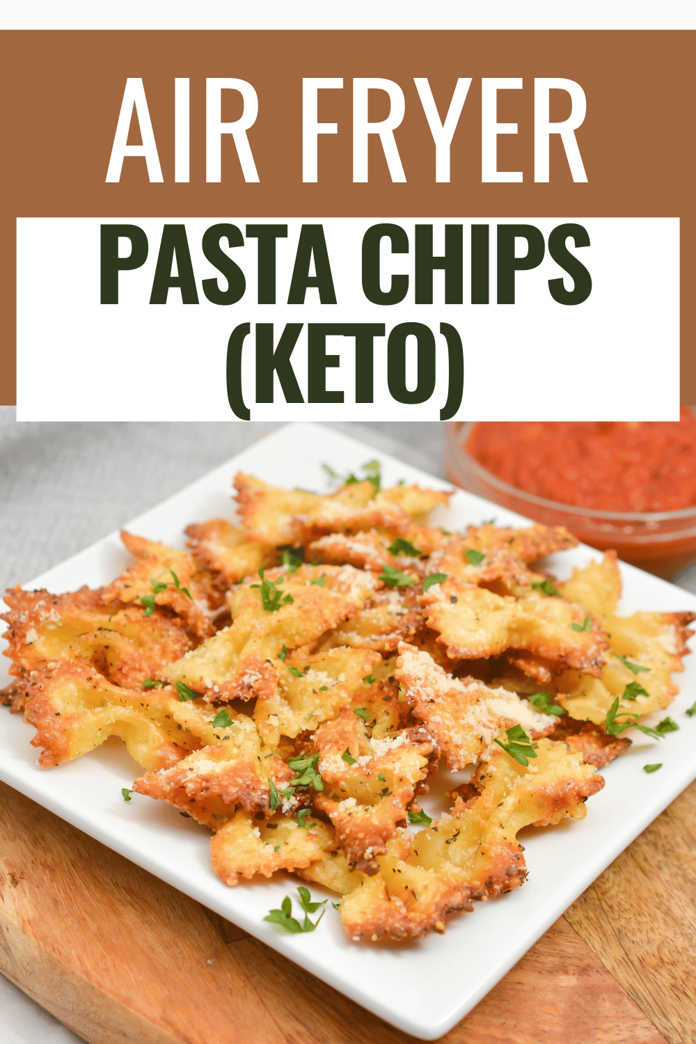 air fryer pasta chips on a white plate next to pasta sauce in a glass bowl with title text reading Air Fryer Pasta Chips (Keto)