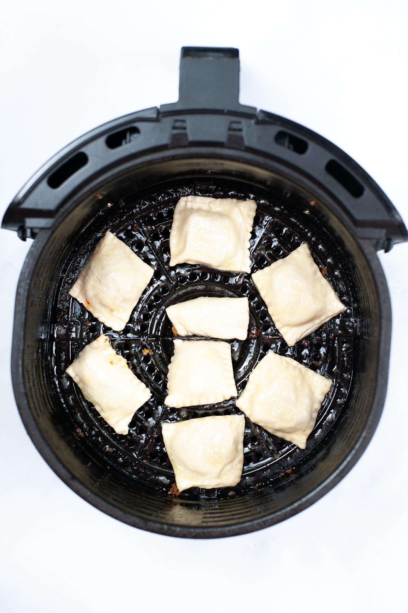 Pizza rolls inside the air fryer ready to be cooked