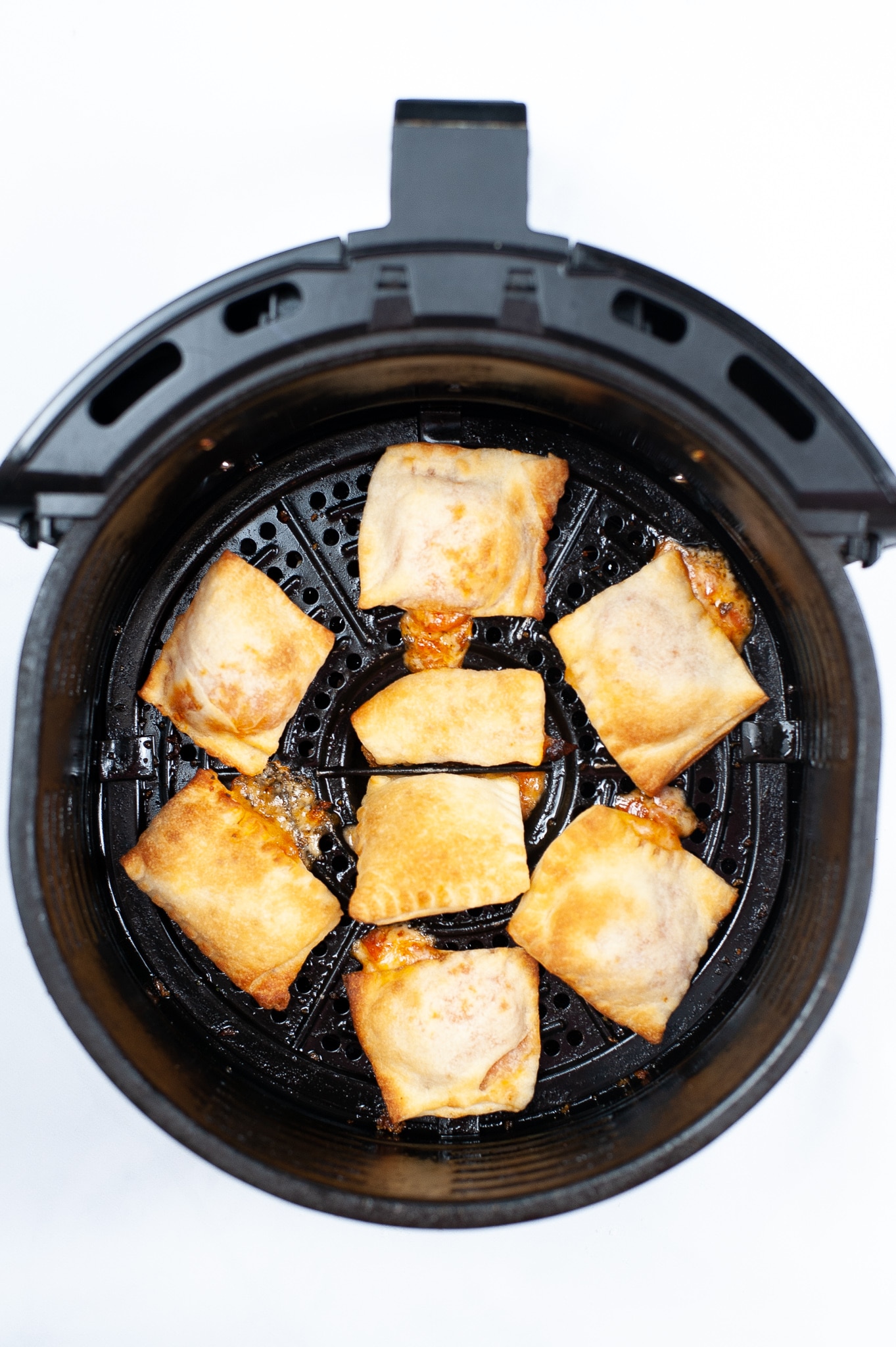 cooked pizza rolls inside the air fryer 