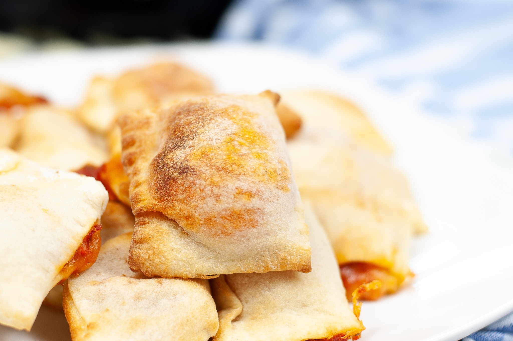 a closeup of Air Fryer Pizza Rolls on a white plate 