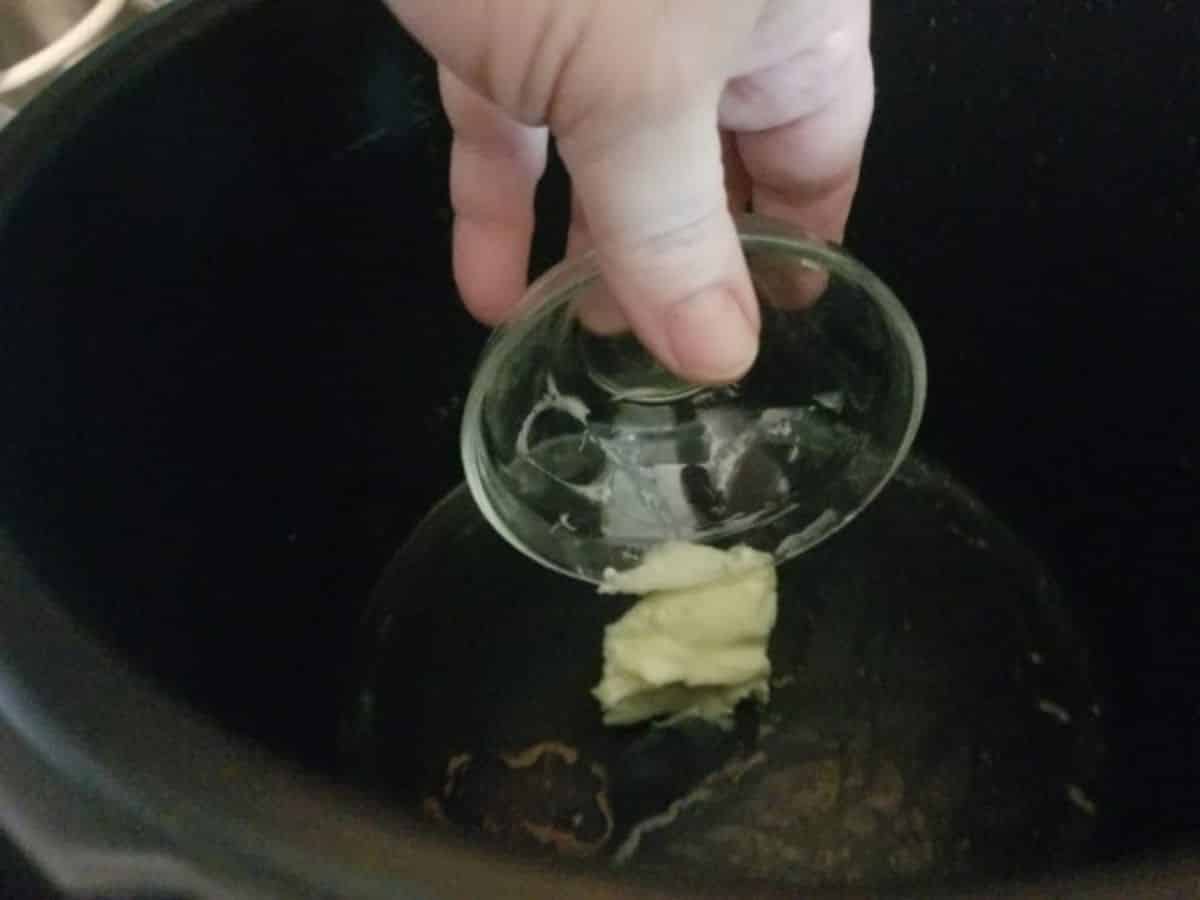 butter being added to oil in the pot
