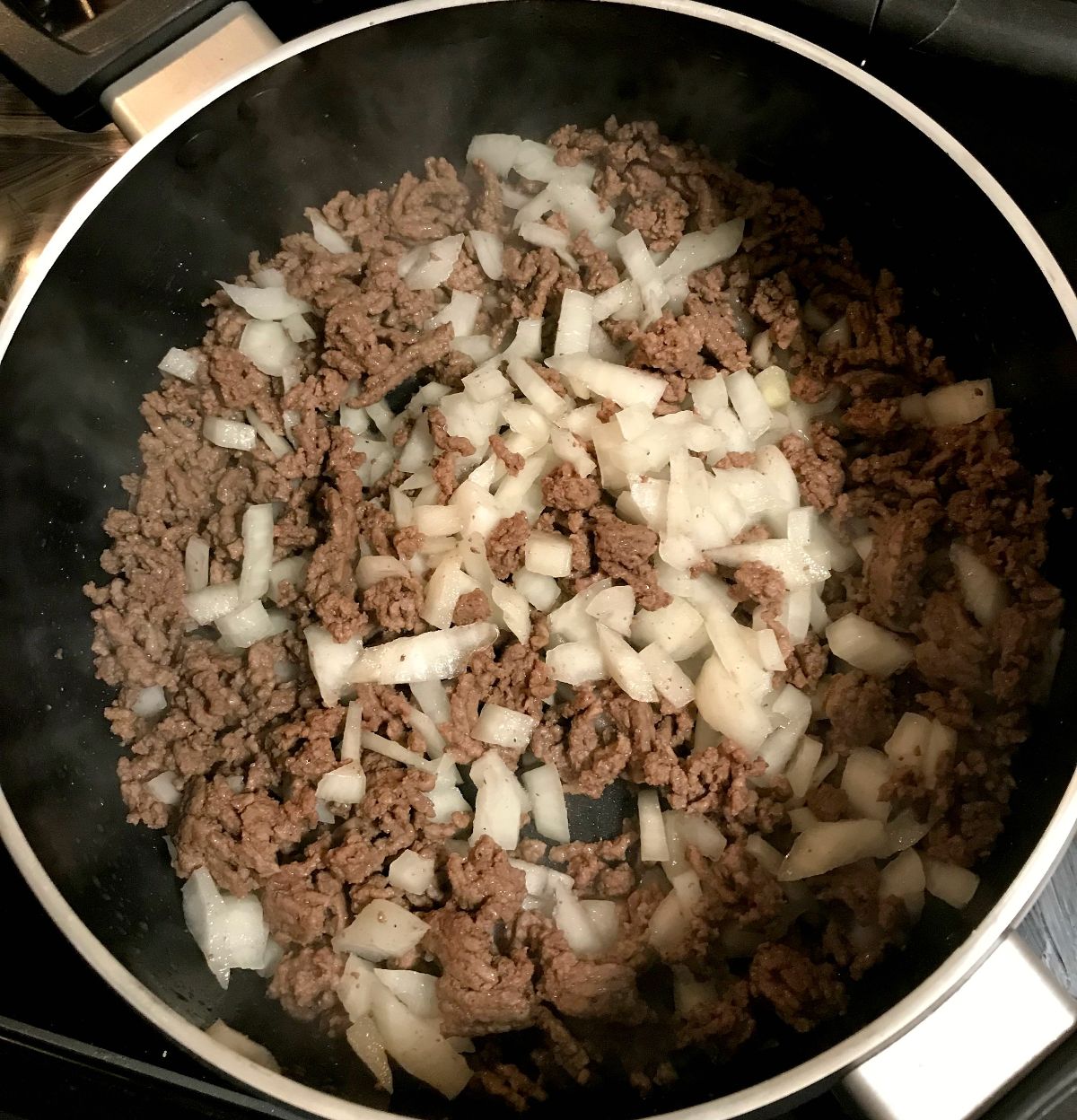 Ground beef and onions in a large skillet