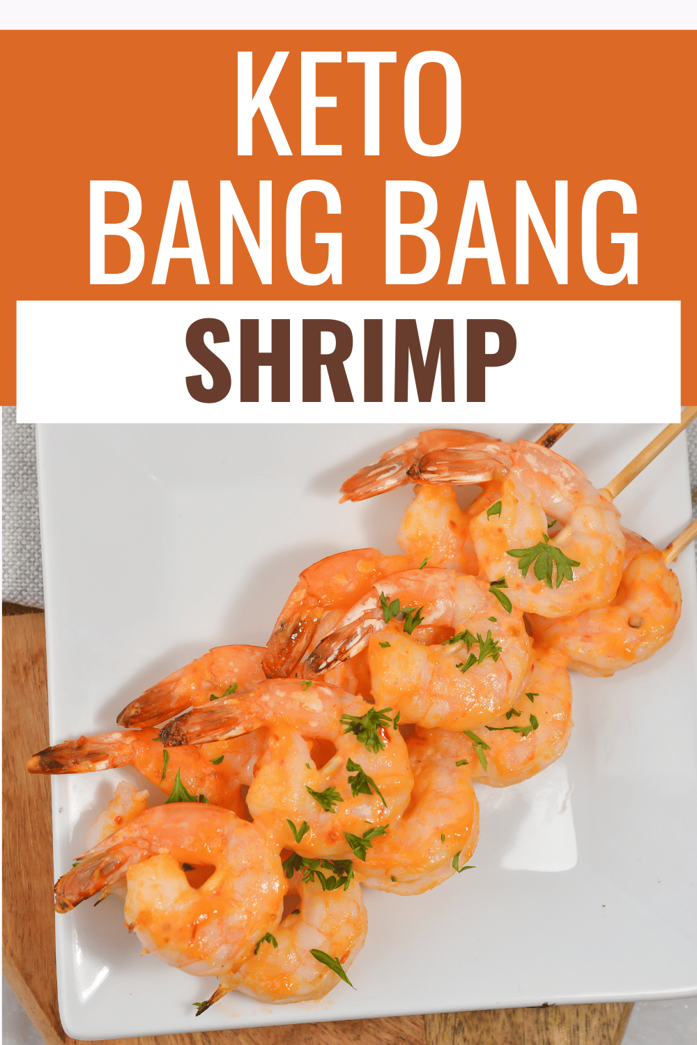 Keto bang bang shrimp on a plate, garnished with chopped parsley with title text reading Keto Bang Bang Shrimp