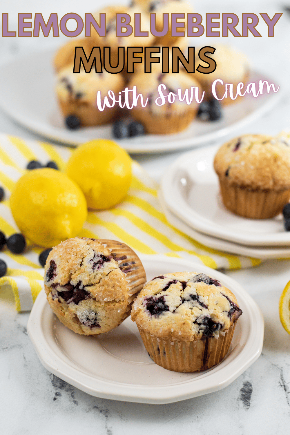 Lemon Blueberry Muffins With Sour Cream on several plates surrounded by blueberries and lemons with title text reading Lemon Blueberry Muffins With Sour Cream