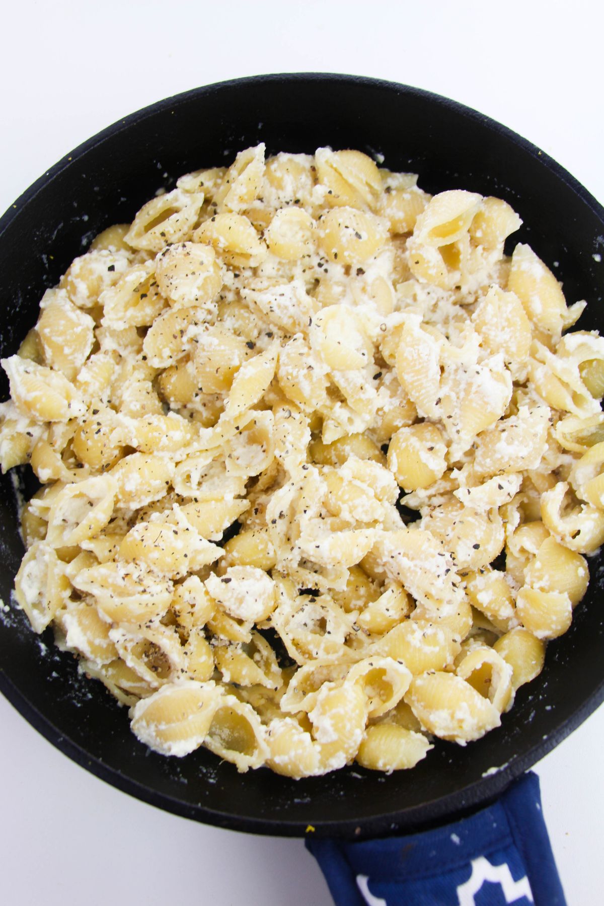  Parmesan cheese, lemon zest, salt, pepper, and pasta in a skillet