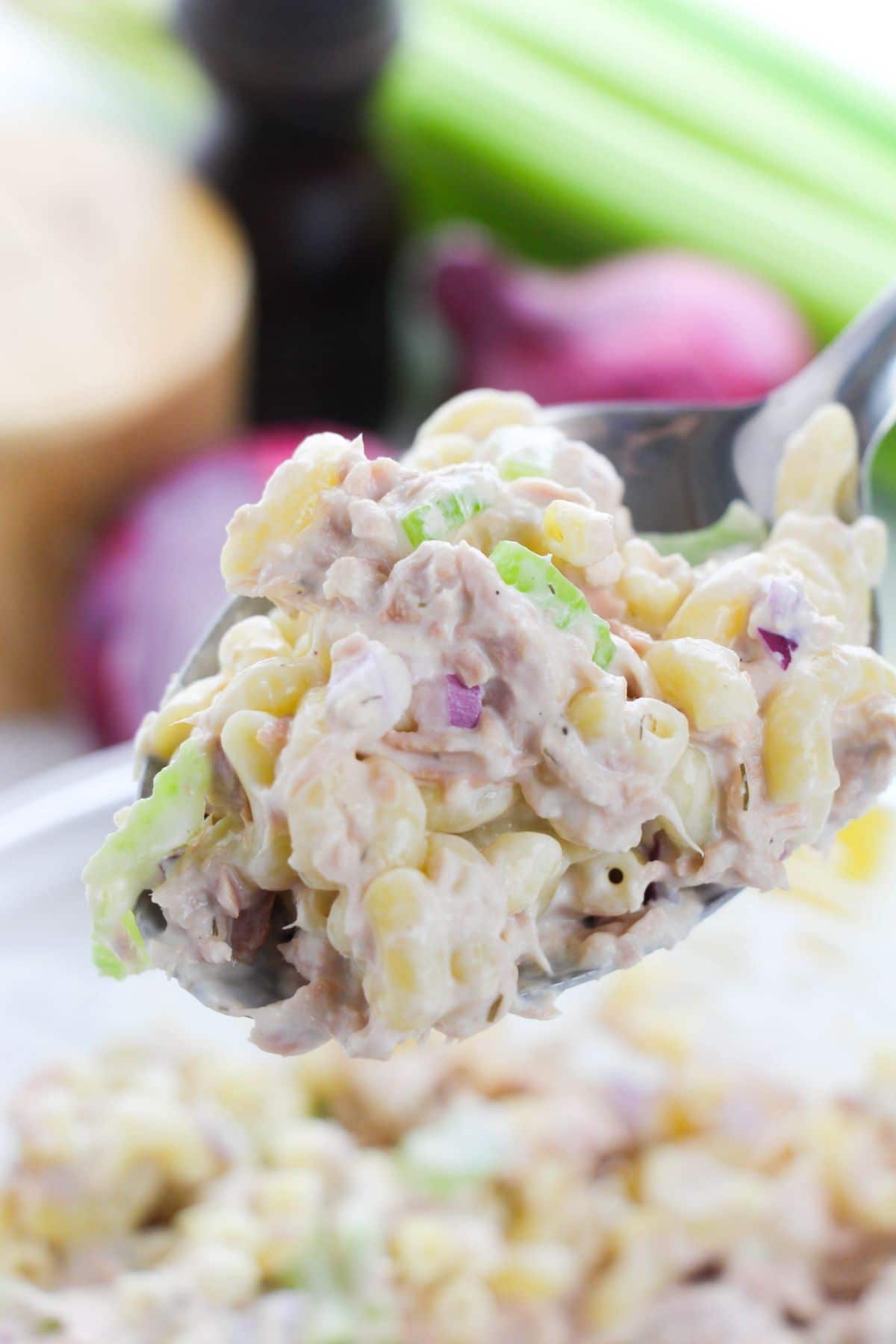 a close up of tuna pasta salad on a spoon 