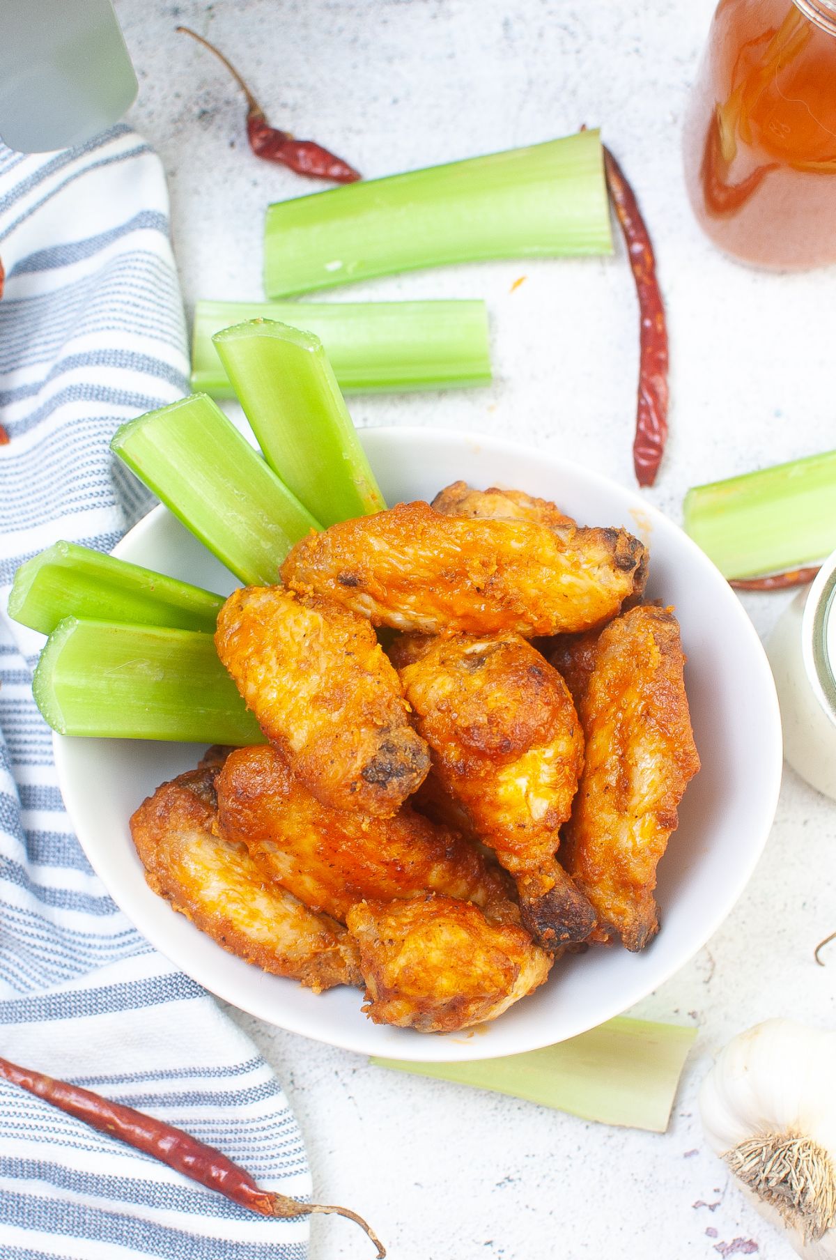 Air Fryer Buffalo Wings in a large bowl next to celery stalks