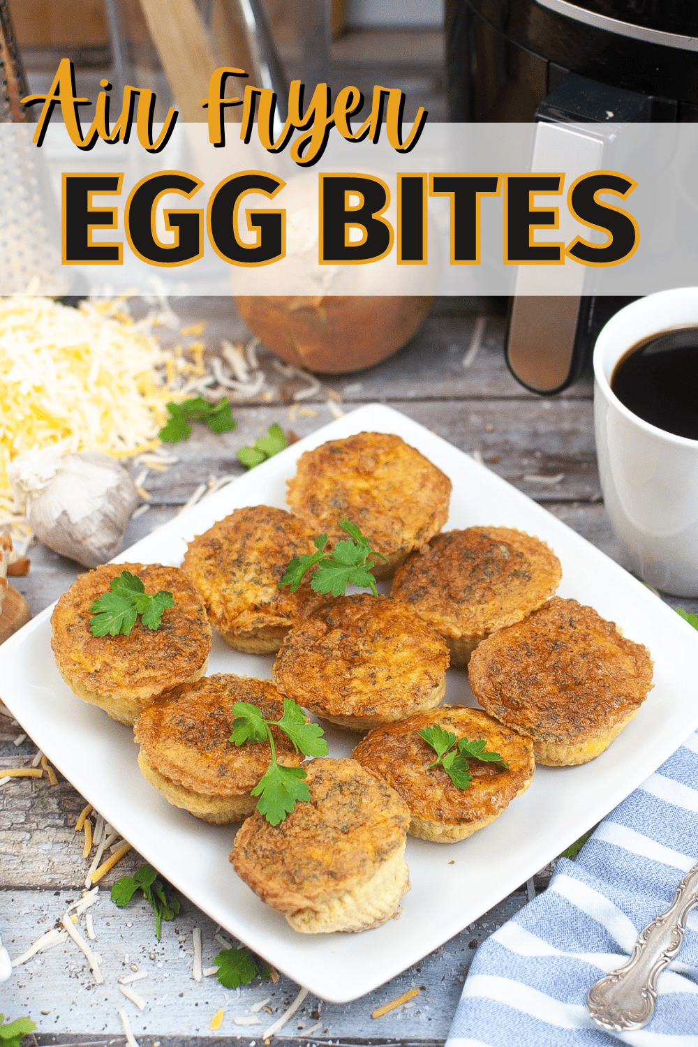 air fryer egg bites on a white plate with shredded cheese and a cup of coffee in the background with title text reading Air Fryer Egg Bites