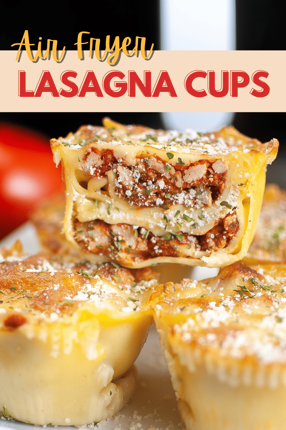a closeup of an Air Fryer Lasagna Cup cut in half stacked on more lasagna on a plate with title text reading Air Fryer Lasagna Cups