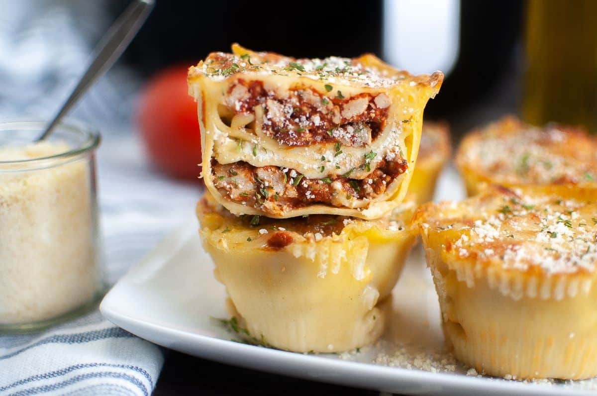 an Air Fryer Lasagna Cup cut in half stacked on more lasagna on a plate