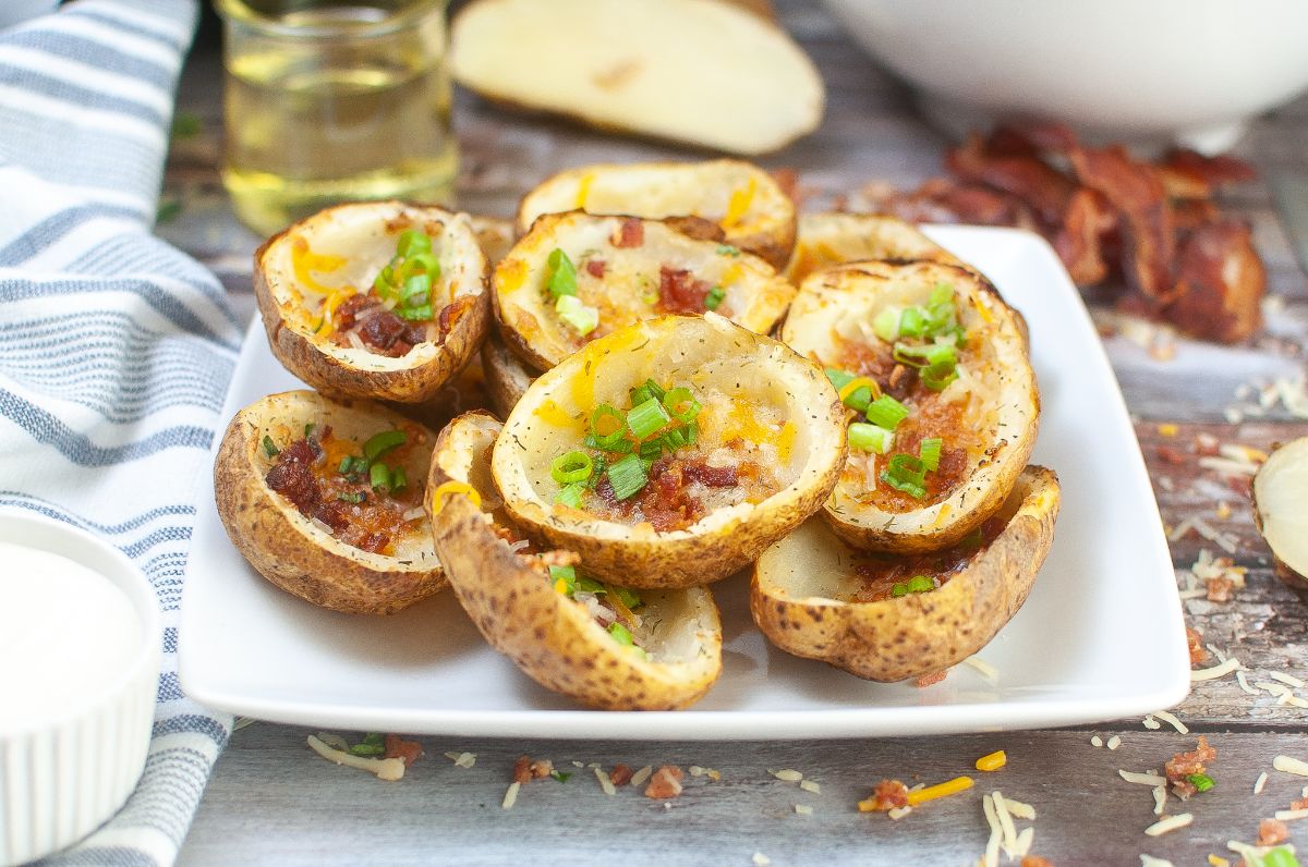 Air Fryer Potato Skins on a plate with potato and ranch dressing on the side