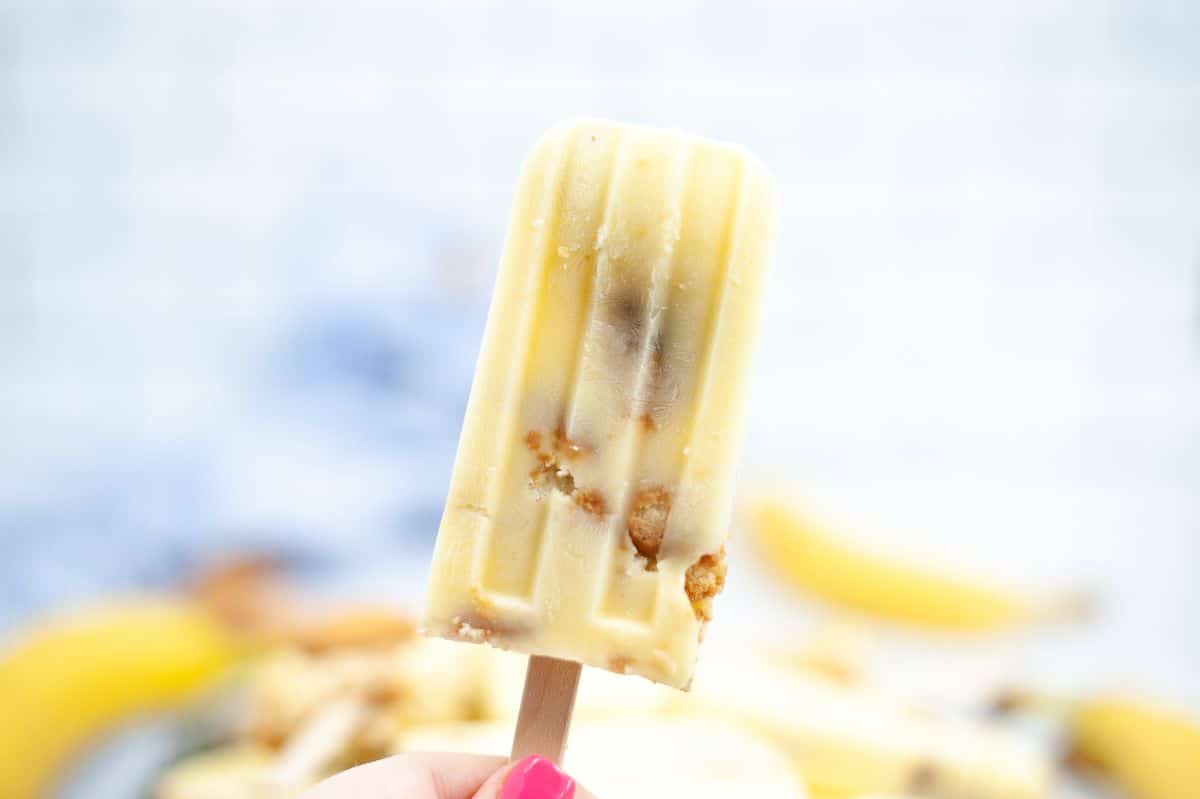 a hand holding a Banana Pudding Popsicle