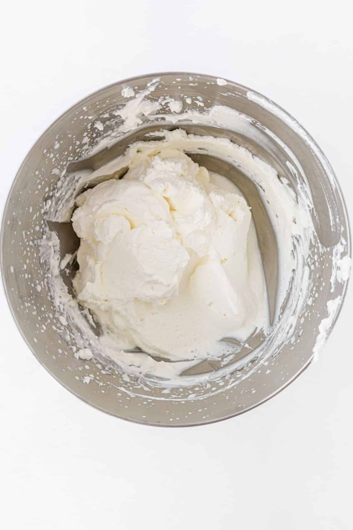 cream beaten to stiff peaks in a mixing bowl
