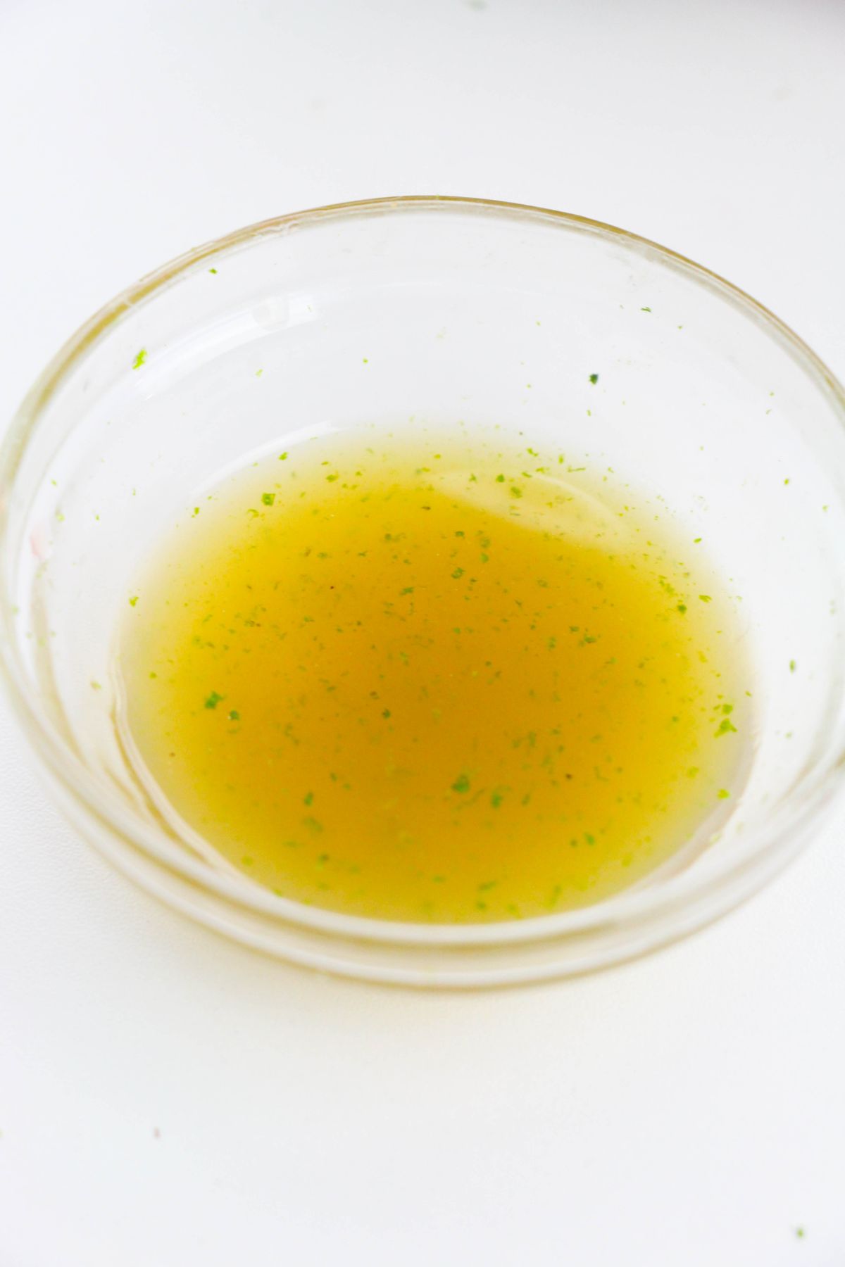 Honey, lime juice, and lime zest in a small glass bowl