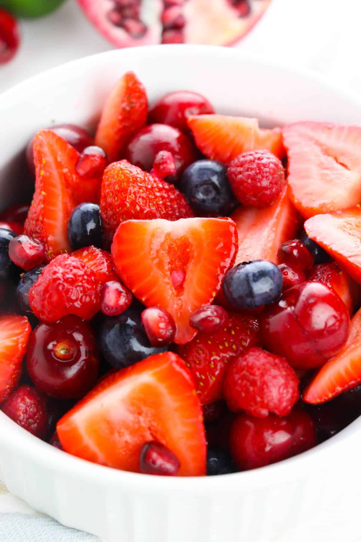 a closeup of Fruit Berry Salad with Honey Lime Dressing in a bowl